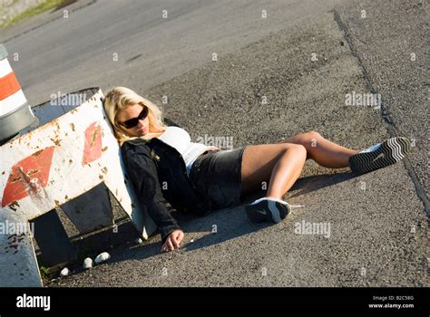 Drug Addicted Women Lying On The Asphalt Stock Photo Alamy