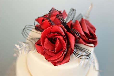 Three Flower Cake Topper With Low Black Loops And Silver Fern