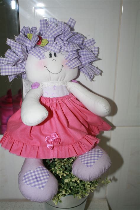 A Stuffed Animal In A Pink Dress Next To A Potted Plant