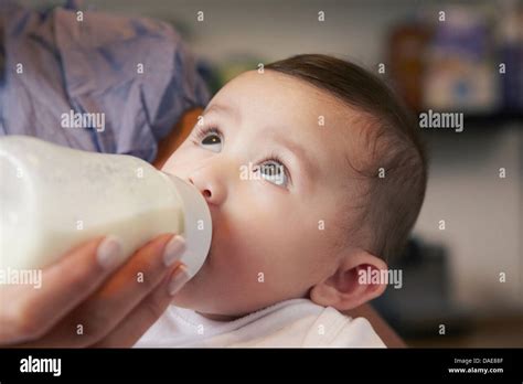 Baby Girl Drinking Bottle Of Milk Stock Photo Alamy