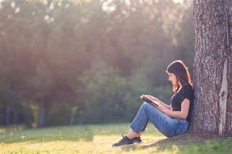 Girl Reading Book Under A Tree Stock Photo Download Image Now Istock