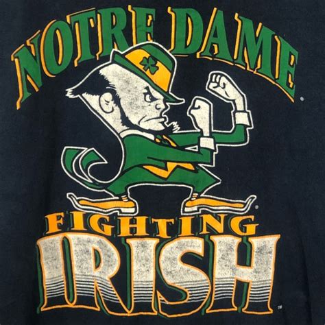 Discover the story behind the notre dame fighting irish nickname, notre dame traditions to include the irish guard, leprechaun mascot, four horsemen fighting irish game day traditions, mascots nickname story and more no other university proudly boasts the tremendous history of excellence. Jostens Sportswear Shirts | Notre Dame Fighting Irish Logo ...