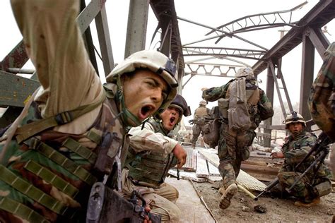 Marines Urge Fellow Infantrymen To Rush Across The Damaged Baghdad