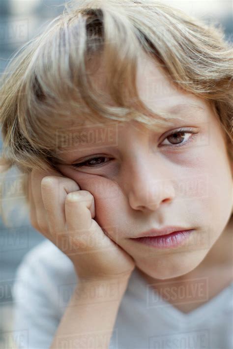 Boy with bored expression on face, portrait - Stock Photo - Dissolve