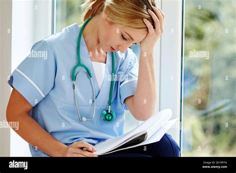 Tired nurse at work Stock Photo - Alamy