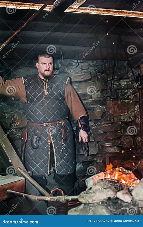 A Blacksmith In A Medieval Forge Historical Reconstruction Of The