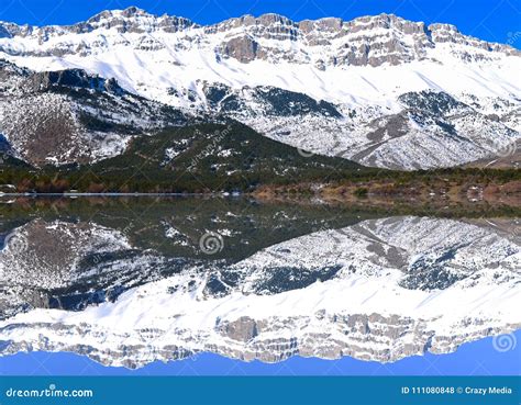 Snowy Mountains Reflecting In Lake Stock Photo Image Of Capped Water