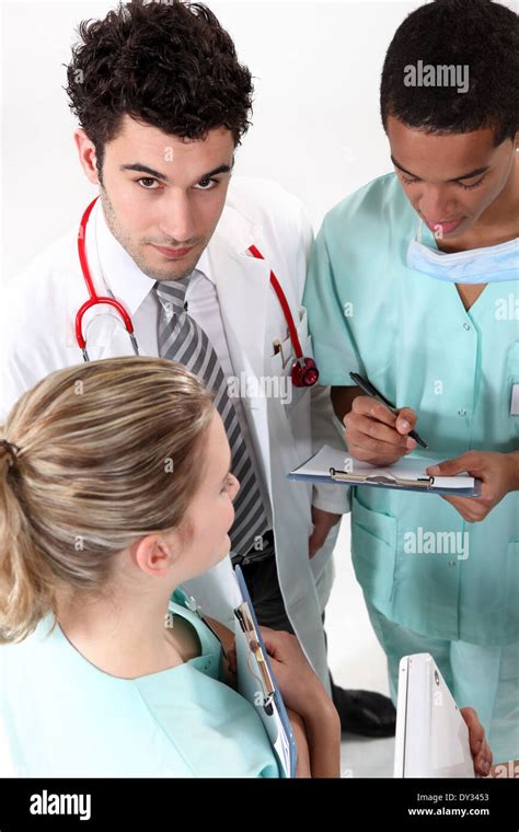 A Team Of Medical Professionals Conferring Stock Photo Alamy