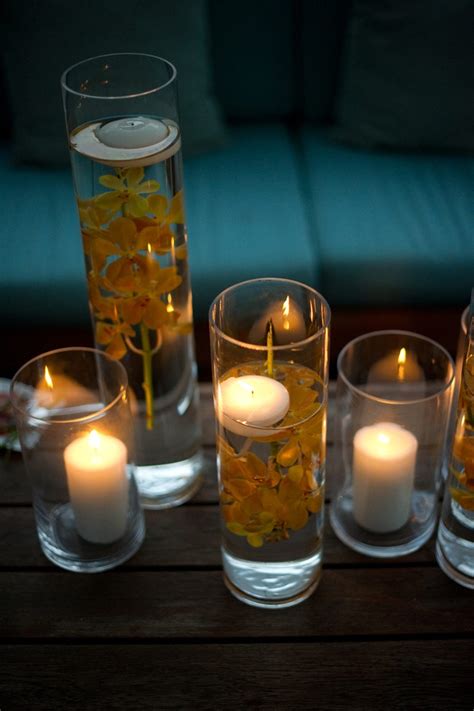 Floating Candles In Vases With Flowers Submerged In Water Floating
