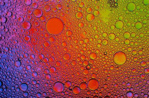 Premium Photo Background Of Colorful Oil Drops In Water Surface