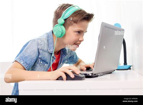 Boy In Headphones Playing Video Game On Laptop Stock Photo Alamy