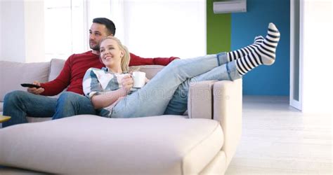 Young Couple On The Sofa Watching Television Stock Image Image Of Beautiful Casual 96467645