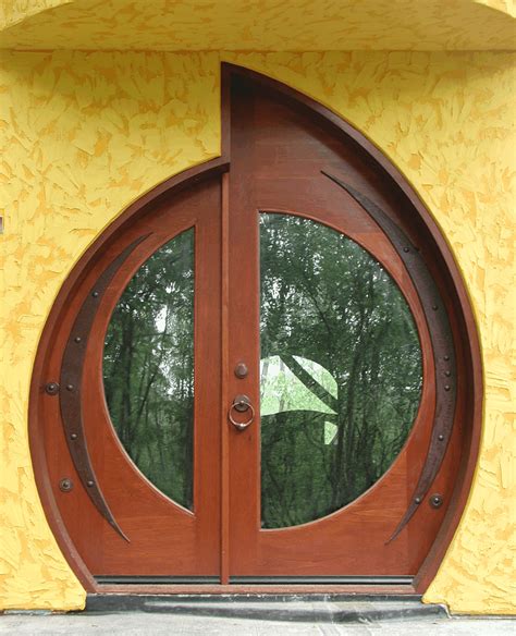 A Wooden Door With Two Circular Glass Panes In Front Of A Yellow Wall
