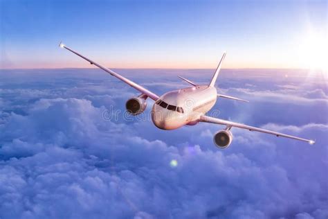 Commercial Airplane Flying Above Clouds Stock Photo Image Of Purple