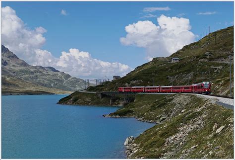A Rhb Bernina Local Train By The Lago Bianco Withe Lake Between