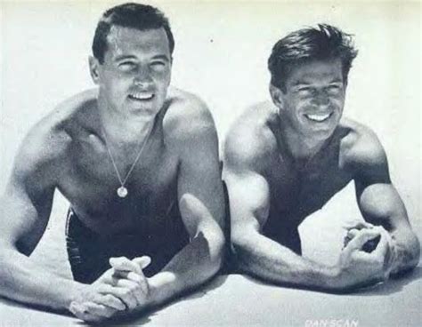Two Men In Bathing Suits Posing For A Photo