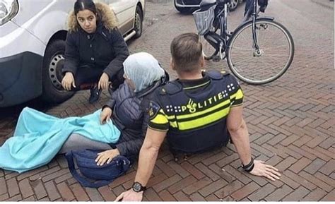 dutch police officer sat here for half an hour to make this lady who just got ran over able to