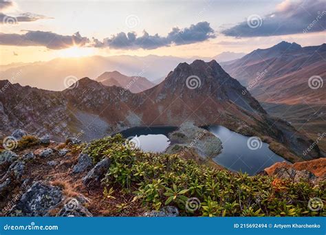 Beautiful Mountains At Sunset In Clouds Gold Alpine Field Lakes And