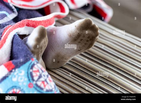 Pair Of Child Feet In Dirty Stained White Socks Kid Soiled Socks While