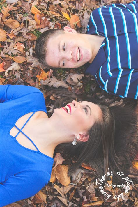 Two People Laying On The Ground With Leaves In Front Of Them And One