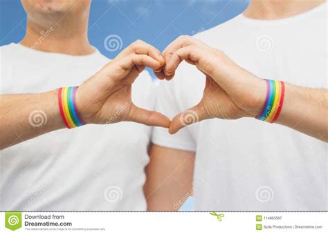 gay couple with rainbow wristbands and hand heart stock image image of background awareness