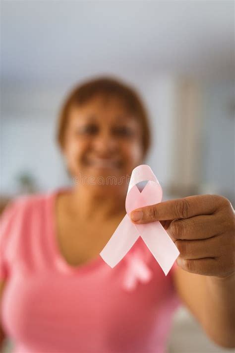 Smiling Senior Woman Showing Pink Ribbon Representing Breast Cancer Awareness Stock Image