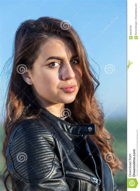 Portrait Of Sweet Brunette Girl In Leather Jacket Looking At The Stock