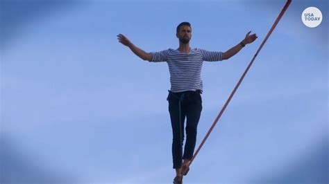 Tightrope Performer Walks From Eiffel Tower Over Paris River