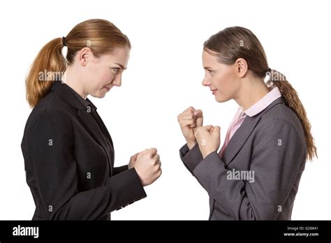 Studio Shot Of Two Business Women With Their Fists Raised Ready For A