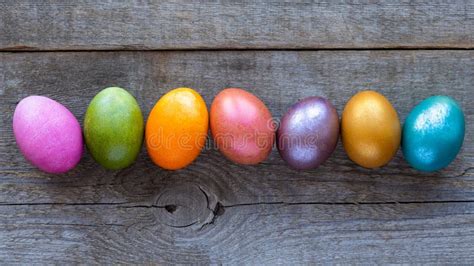 Beautiful Multi Colored Easter Eggs Lie On A Old Wooden Background