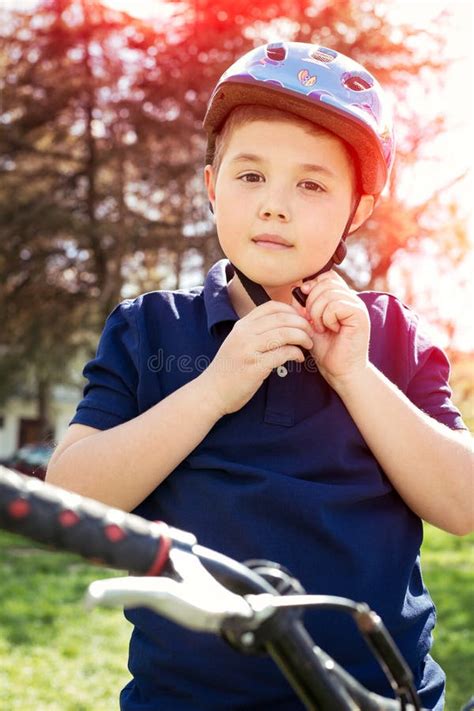 Boy Putting On A Bike Helmet Stock Photo Image Of Active Person