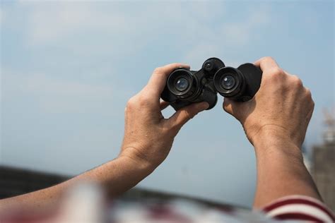 Close Up Of Man Holding Binoculars Photo Free Download