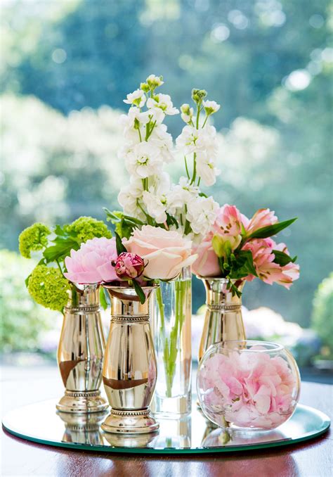 A Cluster Of Small Vases With A Mixture Of Different Blooms To Match