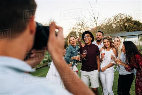 Man Taking Picture Of His Friends During A Outdoor Party Group Of