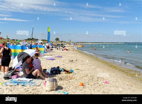 A Crowded Knoll Beach At Studland Bay On A Hot Sunny Summers Day