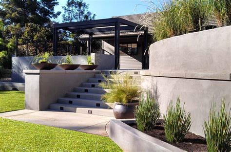 An Outdoor Area With Grass Plants And Concrete Steps Leading Up To A