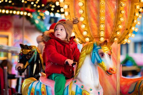 Child Riding Carousel On Christmas Market — Stock Photo © Famveldman