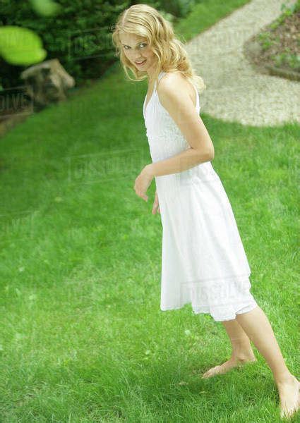 Babe Woman Wearing White Dress Standing Barefoot On Grass Stock Photo Dissolve