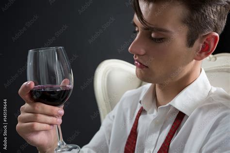 Thoughtful Androgynous Man Holding Wine Glass Stock Photo Adobe Stock