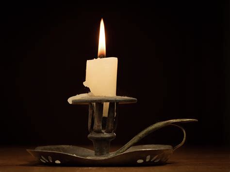 Nearly Burnt Down Burning Candle On Old Candle Holder Photograph By