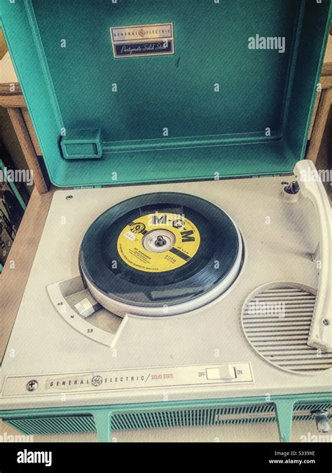 Vintage 1960s Portable Phonograph Player With A Vinyl 45 Rpm Record On