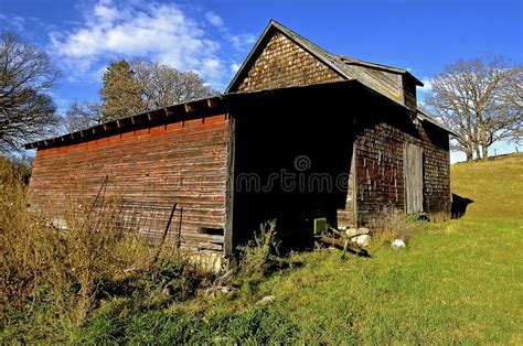 Old Farm Shed Surrounded By Weeds And Fencesblack And White Stock