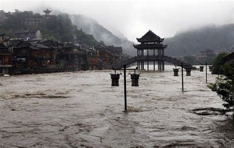 Street Lamps Are Seen Among Floodwaters Next To Partially Submerged Buildings By An Over Flowing