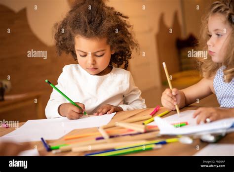 Adorable Multiethnic Children Drawing With Colored Pencils In