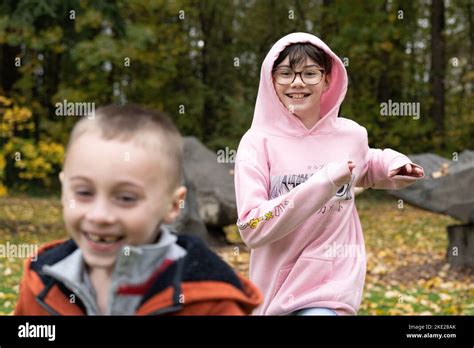 Two Happy Children Running In A Park Playing Stock Photo Alamy