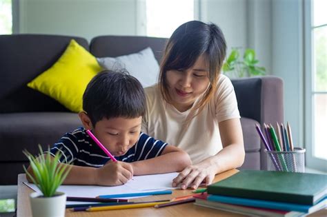 Premium Photo Mother Helping Son Writing Homework Cute Asian Mother