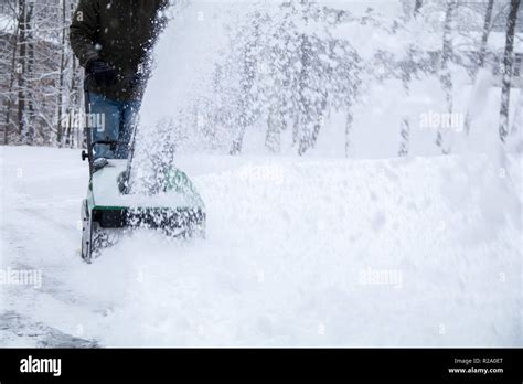 Snowblower In Action During A Snowstorm In The Northeast Maintaining