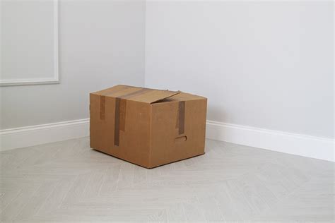 Shabby Cardboard Box In The Corner In An Empty New Room 749481