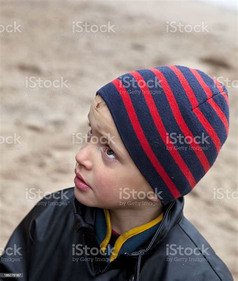 Young Serious Boy With Bruise On Forehead Looking Upwards Stock Photo