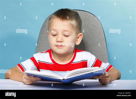 Young Boy Reading A Book Child Kid On Blue Background Holding An Open